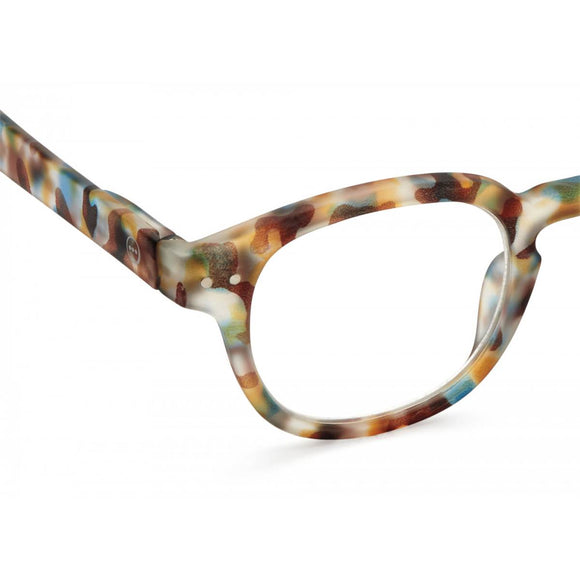 A pair of magnifying reading glasses. The frames are an stylish, bold, square shape in a mottled blue tortoise shell finish.