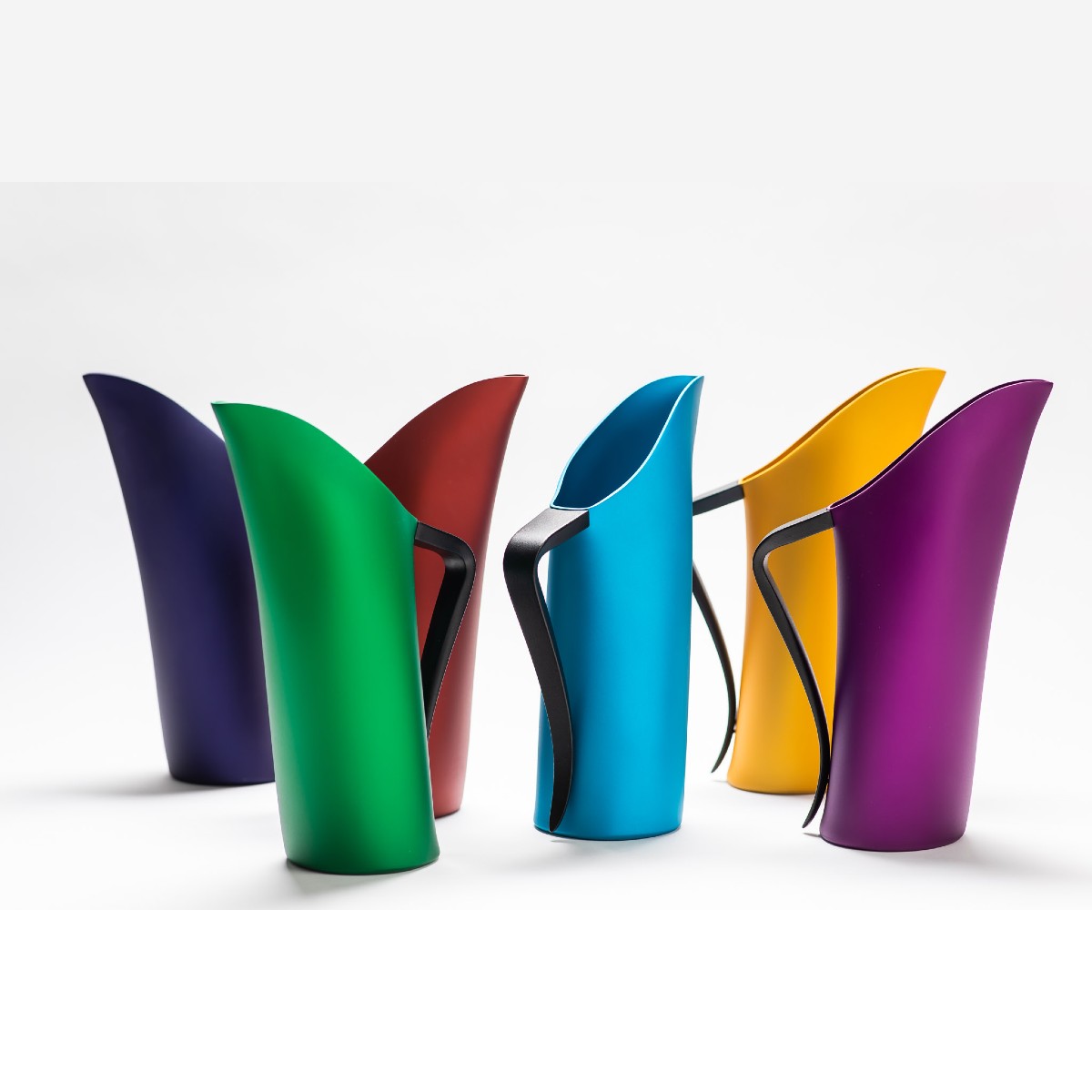 Six FINK water jugs of different colours facing in multiple directions.