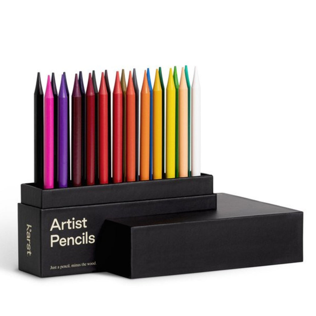 A set of 24 fully pigmented pencils with finely waxed sealing standing upright in its black case with 'Artist Pencils' in white san-serif font. 