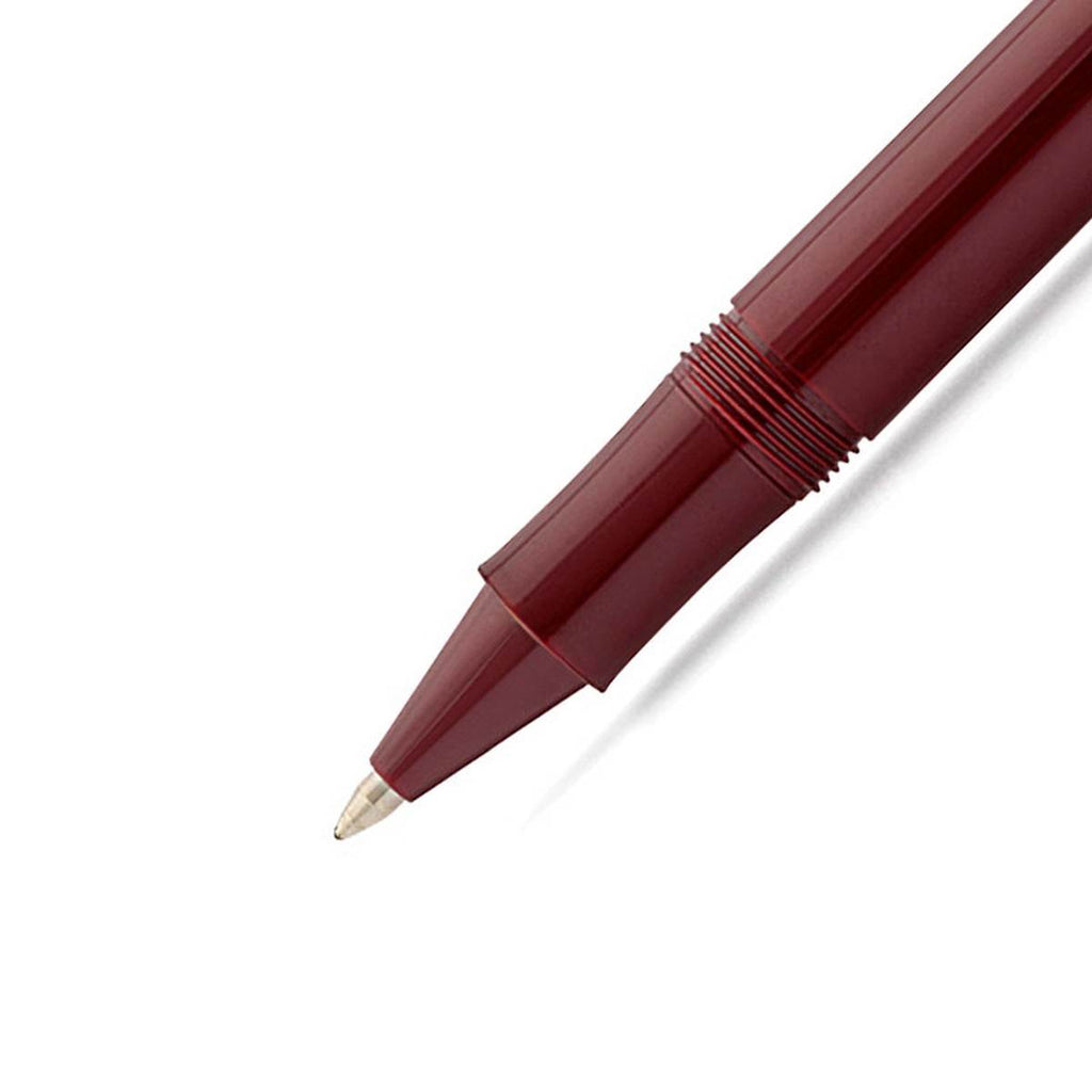 A close up of the gold rollerball nib is attached to the shiny burgundy pen barrel. 