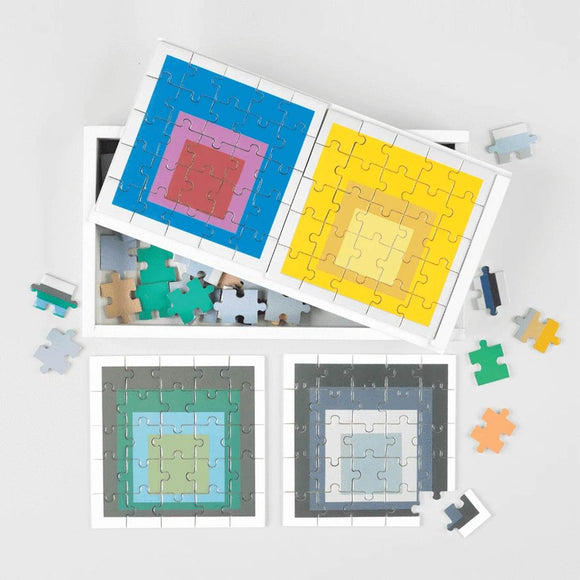 A boxed set of six wooden 25 piece puzzle bearing bright block colour artwork by Josef Albers.