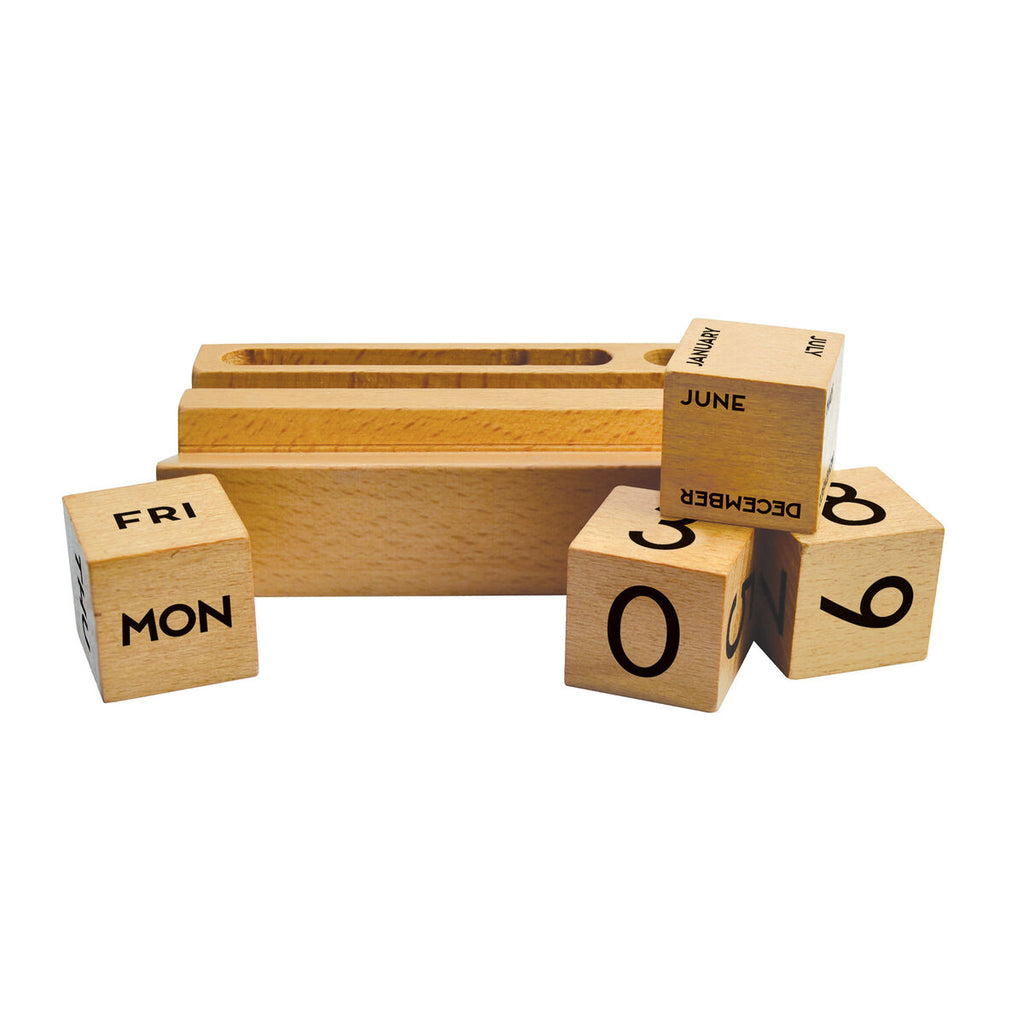 Four changeable cubes in front of the wooden birch slotted block indicating the dates: one for the day, one for the month, and two cubes of number digits for the date. 