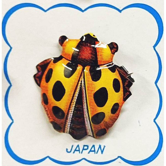 A range of brightly coloured, highly detailed Insect brooches - including a ladybug, cicada and a beetle-shown on cardboard backing.