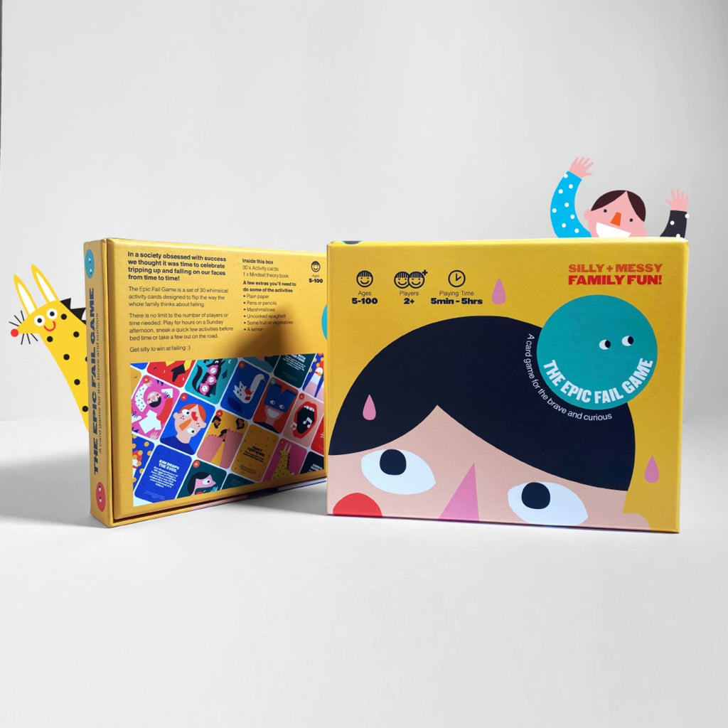 A yellow rectangular box with a green circle over a brunette head looking up stands upright with a little matching person waves from behind in a spotty blue top. On the right is the back of the box standing up at an angle with a giraffe peaking from the side. 