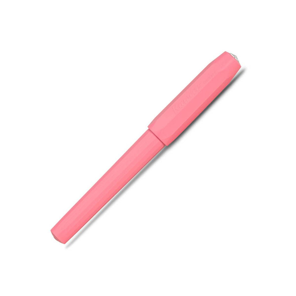 A matte pink pen with its cap on has faceted sides. 