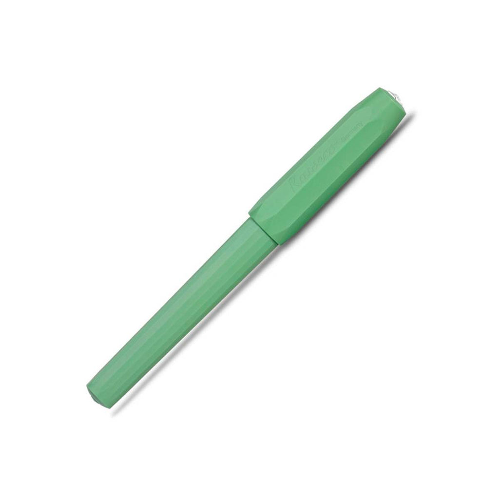 A green pen with its cap on has faceted sides. 
