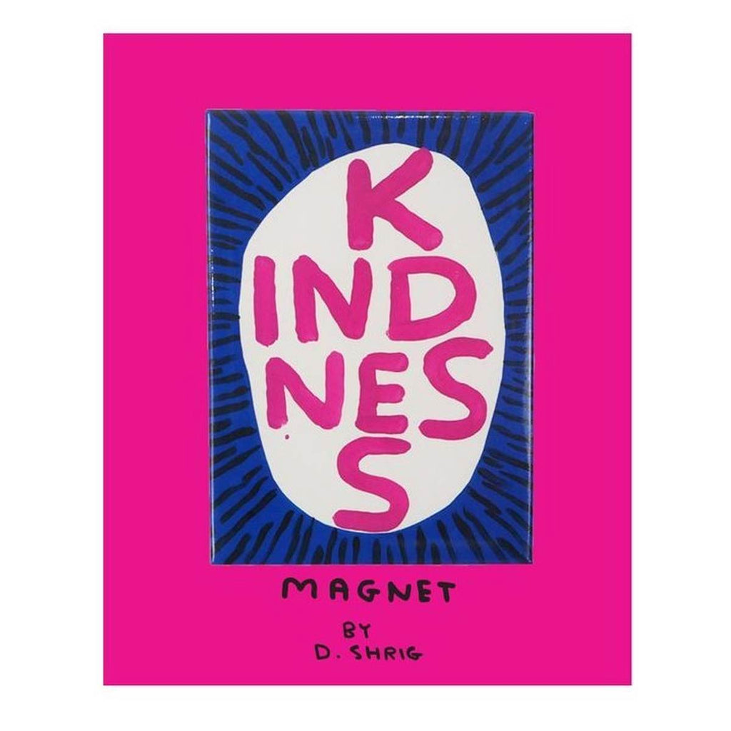 A bright pink packaging card with a black handwritten text 'Magnet by D. Shrig' at the bottom. Above it is the white magnet with a hand-painted capitalised text, 'KINDNESS' in pink inside a white circle surrounded by black lines on a cobalt background. 