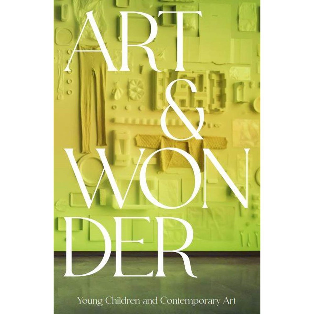'Art & wonder' is capitalised in white over an image of yellow/ green gradient wall with common homeware and clothes hung flat against a wall. 