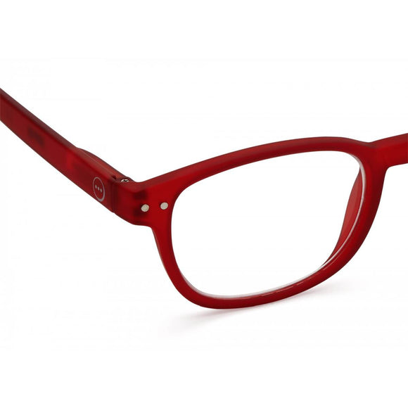 A slightly translucent red pair of magnifying reading glasses. The frames are an elegant, classic, rectangular shape.