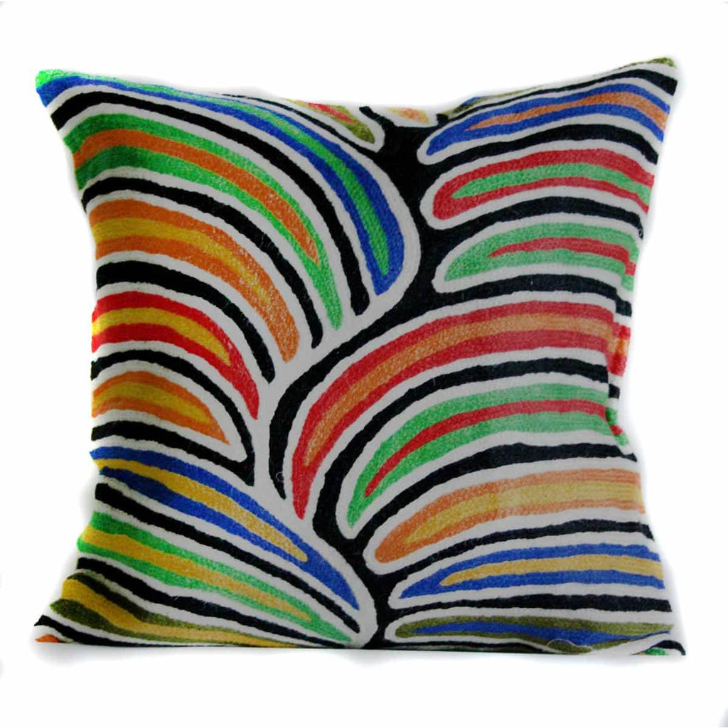 An embroidered wool Cushion featuring an Aboriginal Artwork in red, yellow, orange, green, blue, black and white tones. The design is made largely of colourful lines and shapes separated by black and white lines.
