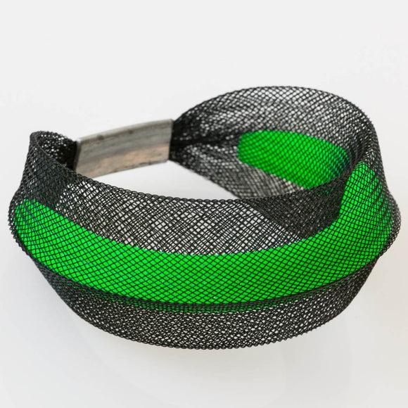 A Black and green bracelet made from finely woven nylon mesh. A Green Mesh tube is visible contained inside a black mesh tube.