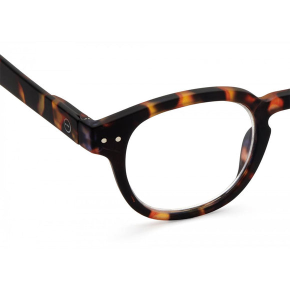 A pair of magnifying reading glasses. The frames are an stylish, bold, square shape in a mottled classic tortoise shell finish.