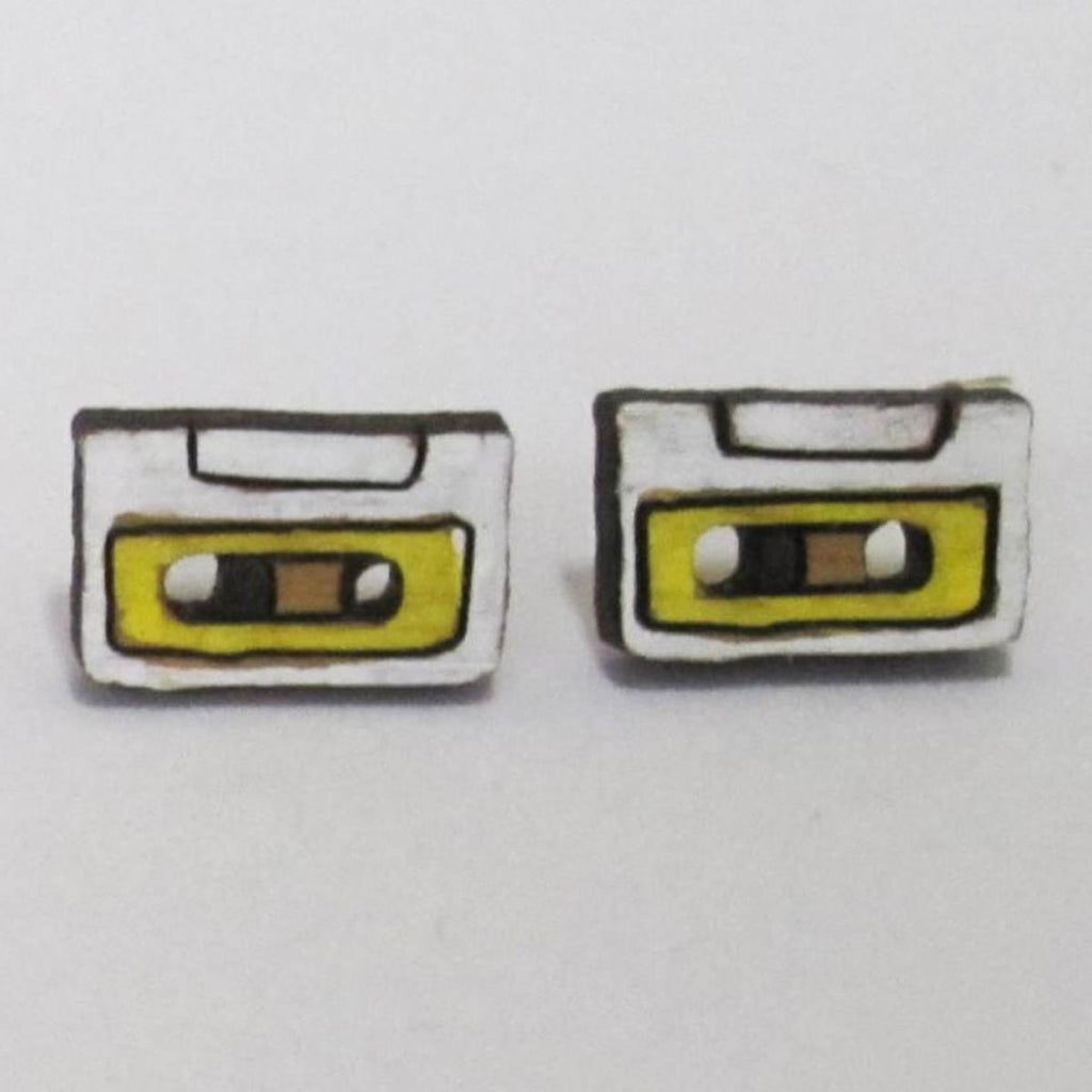 A pair of intricately hand coloured studs depicting cassette tapes in yellow and white. 