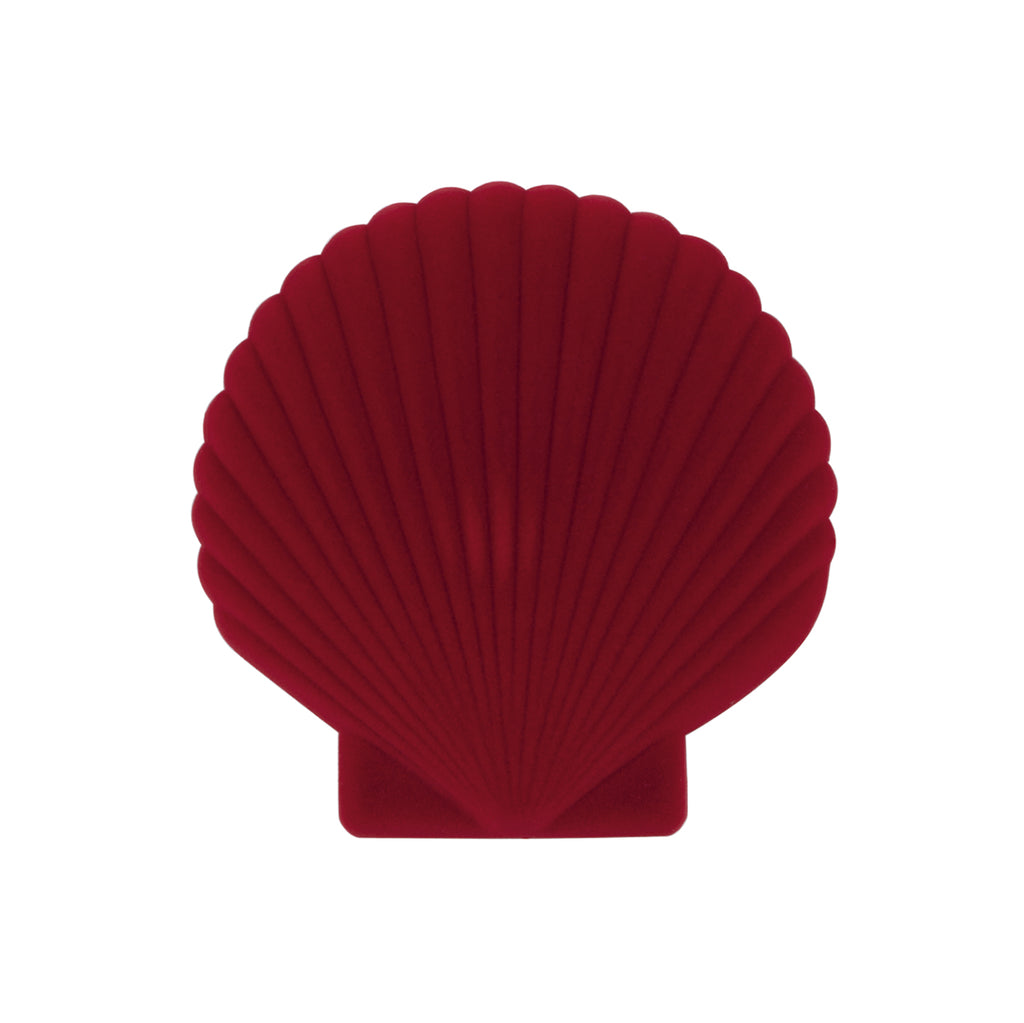 A red velveteen jewellery box in the shape of a shell