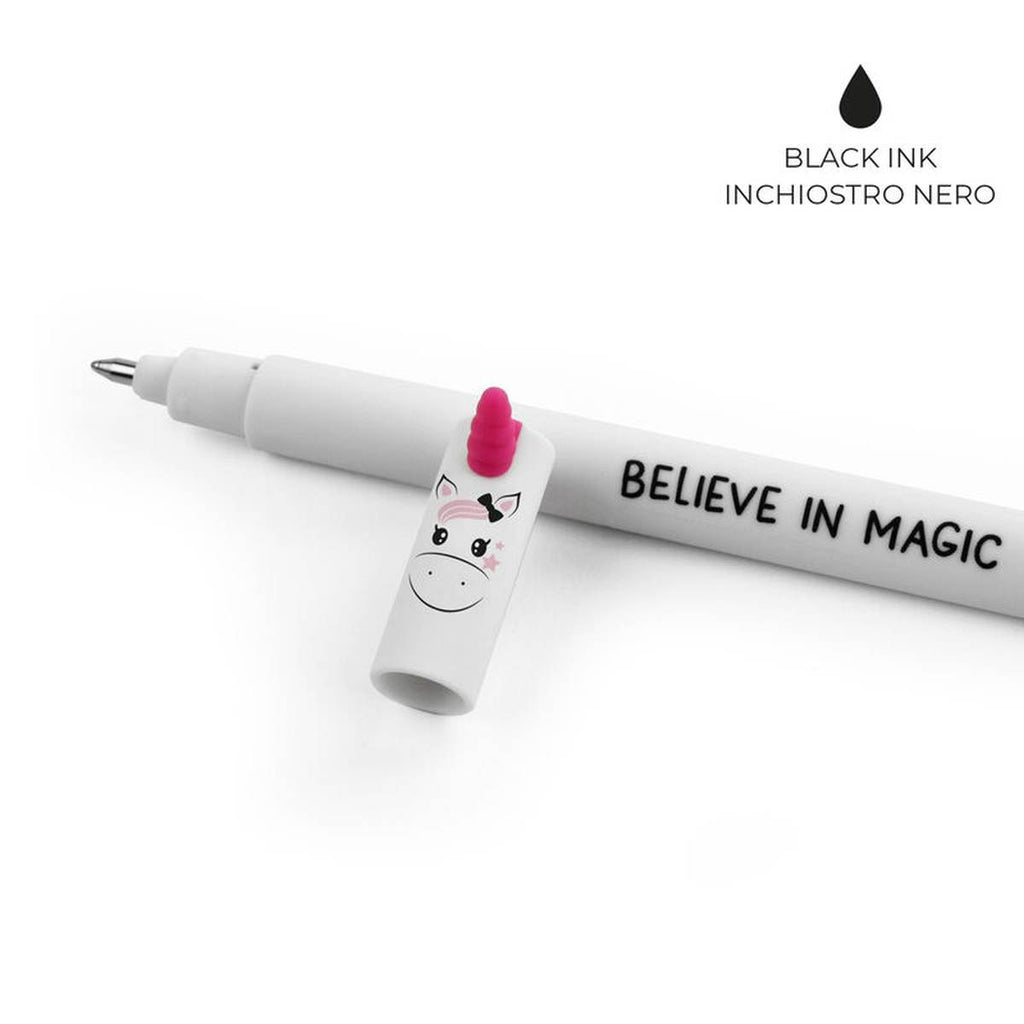The white cap with a unicorn face and a pink horn on the tip laying against the white pen and on the top right corner states "black ink". 