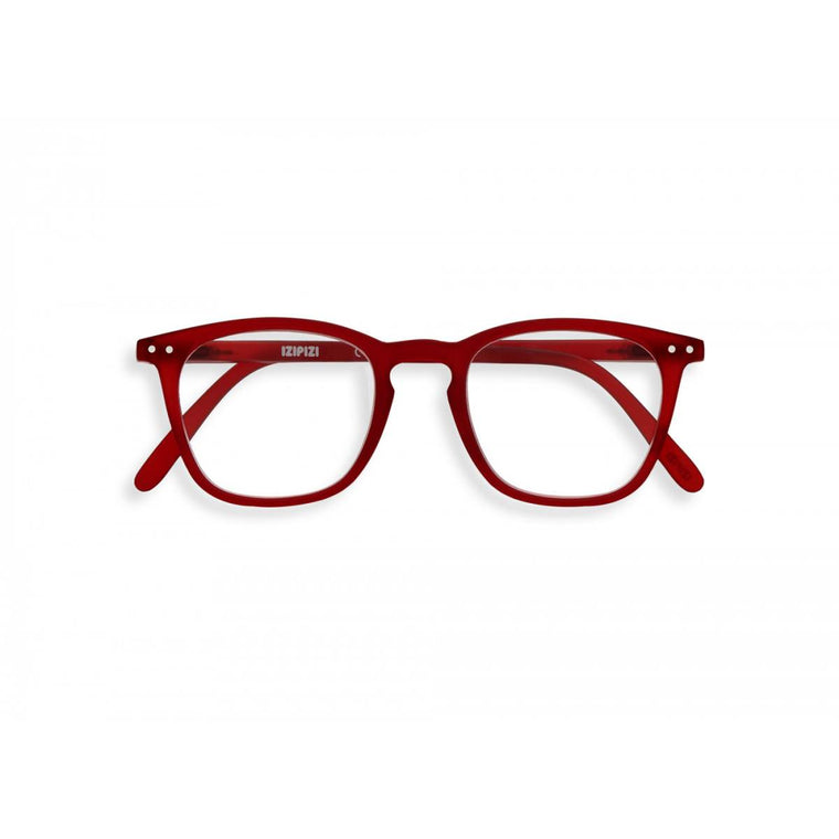 A pair of slightly translucent red magnifying reading glasses. The frames are a large, structured, trapezium shape.