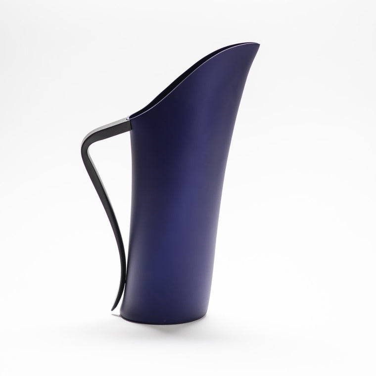 A finely designed sculptural deep blue jug made of anodised aluminium.