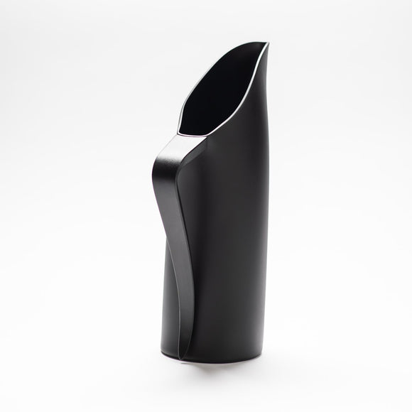 A finely designed sculptural black jug made of anodised aluminium.