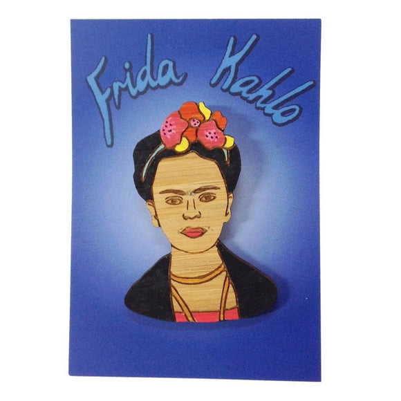 A brooch featuring a portrait of artist Frida Kahlo. Made from bamboo wood and hand painted.