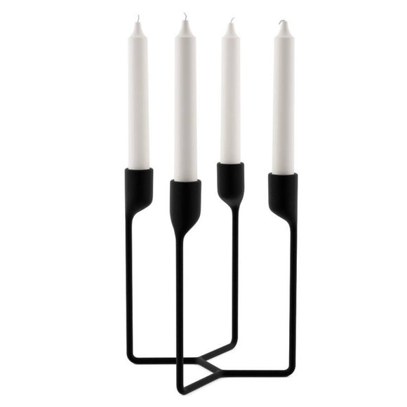 Image featuring the cast iron candlestick in black in the center which features four arms