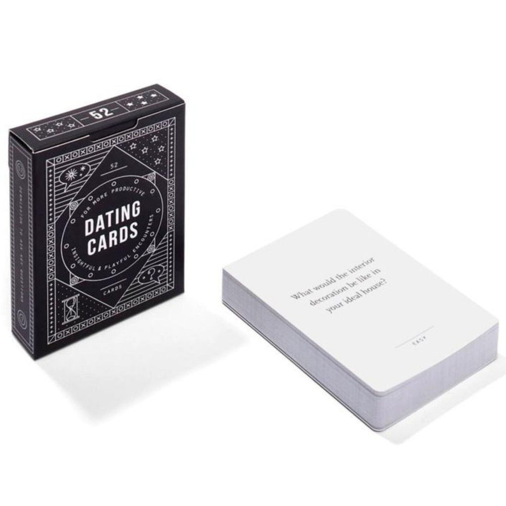 The black packaging box with 'dating cards' in white stands upright on the left. On the right is a stack of white playing cards with black text in the centre. 