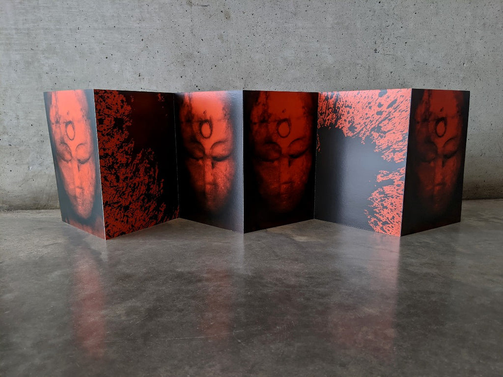 A concertina postcard set of 6 connected postcards is shown open. Each postcard features reproductions from the artwork 'Book of Kuan-Yin' in Red and Black. Displayed in front of a grey concrete wall.