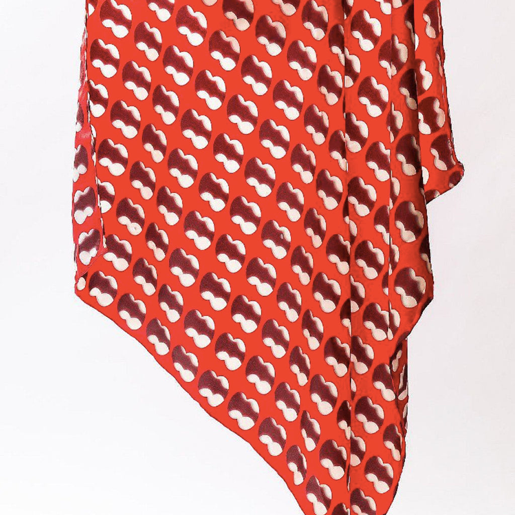 A red silk scarf with patterns of two intersecting circles creating the '8' shape. 