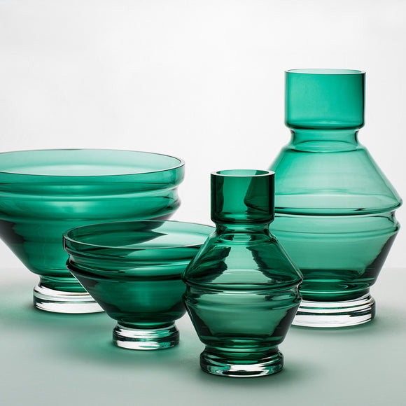 A structural and ridged glass vase in a deep green tone