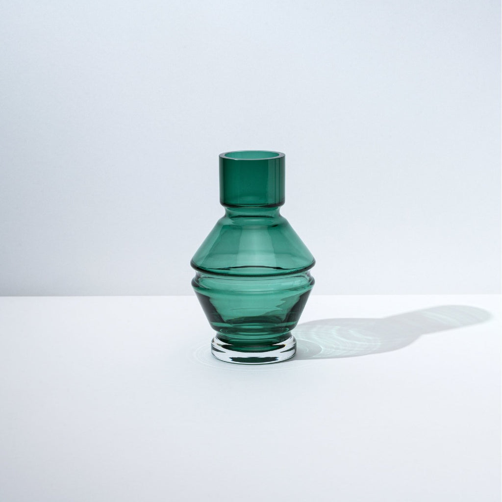 A structural and ridged glass vase in a deep green tone