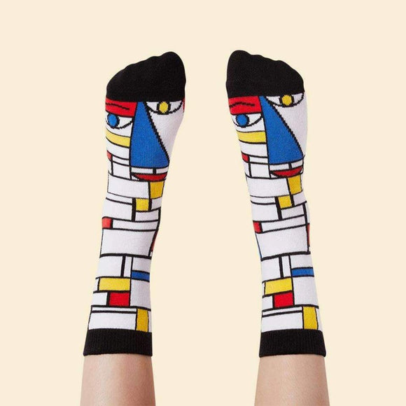Image featuring a pair of socks with a graphic illustration inspired by the work of Piet Mondrian