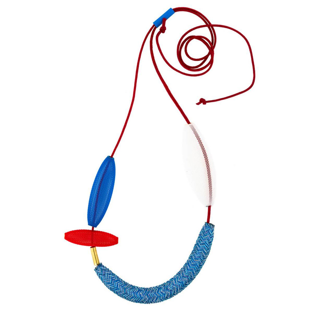 A necklace in variegated blues, white, red and gold. Variegated beads made of heat treated nylon are strung on a waxed cotton cord.