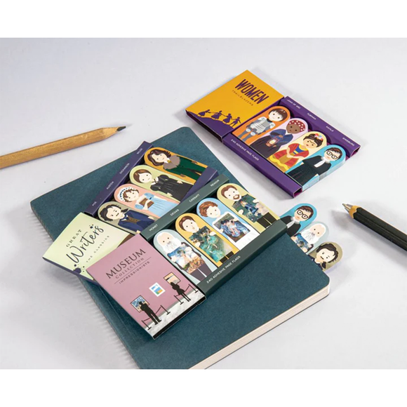 Image featuring the product in the centre, this product has features the colours orange and purple; and on the right has the adhesive paper flags which includes the graphically illustrated characters of joan of arc, harriet tubman, frida kahlo and ruth bater ginsburg