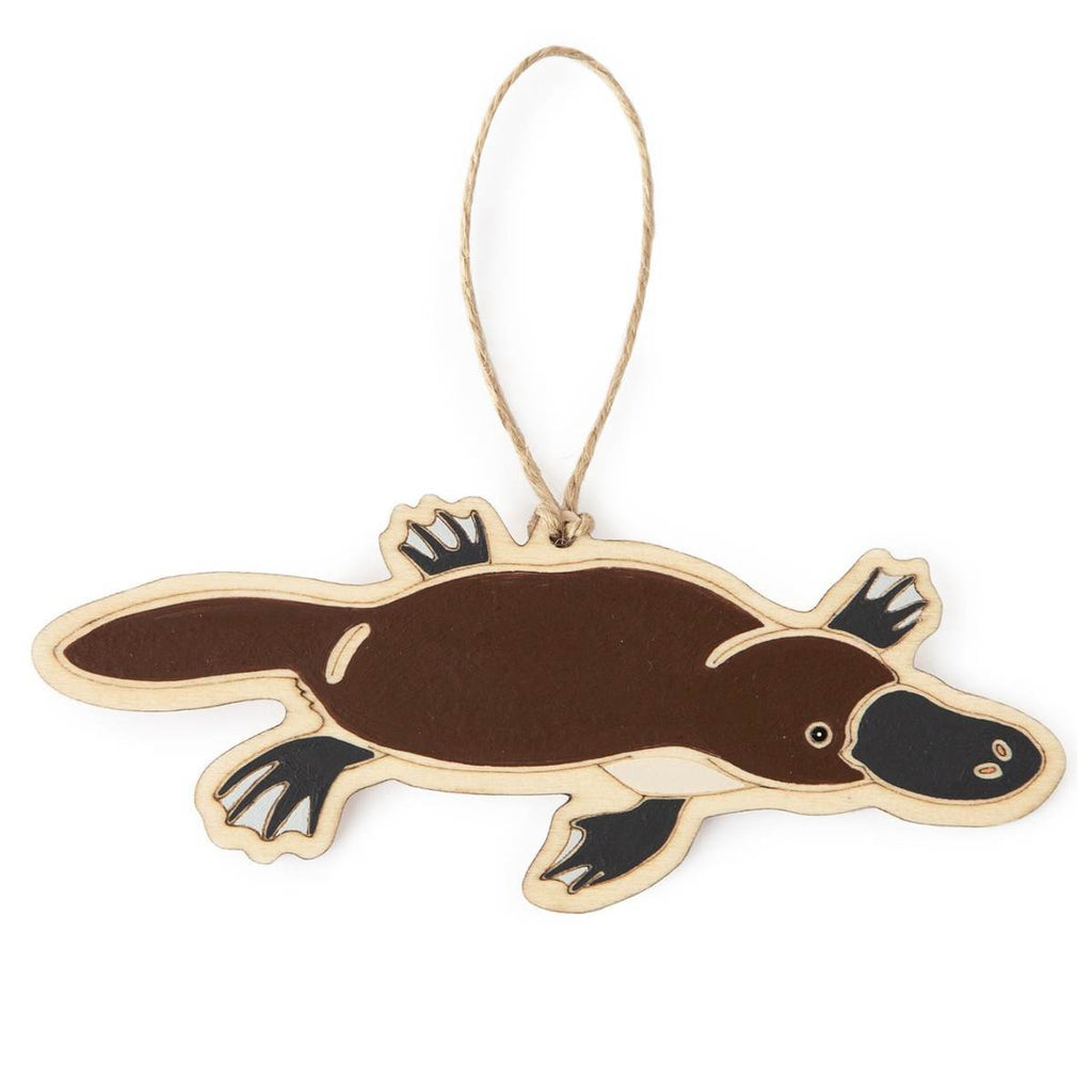 A hanging ornament in the form of a Platypus. Laser Etched flat wood is adorned with brown, black and white hand painting. A Jute string is attached