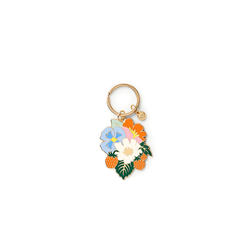 image of a keyring featuring an enamel charm with blue, white, pink and orange flowers, strawberries and green leaves