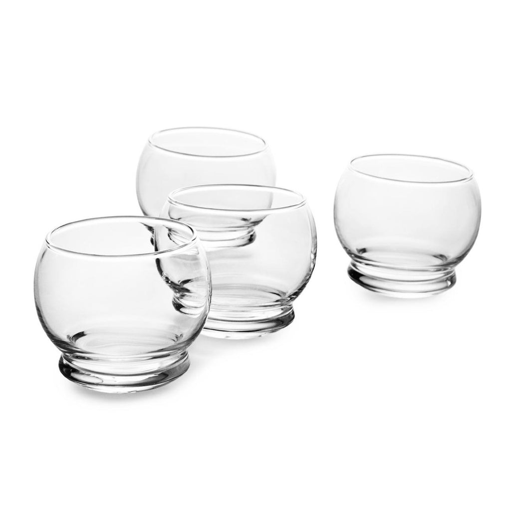 On a white surface are four bulbous glasses with thick rounded bases. 