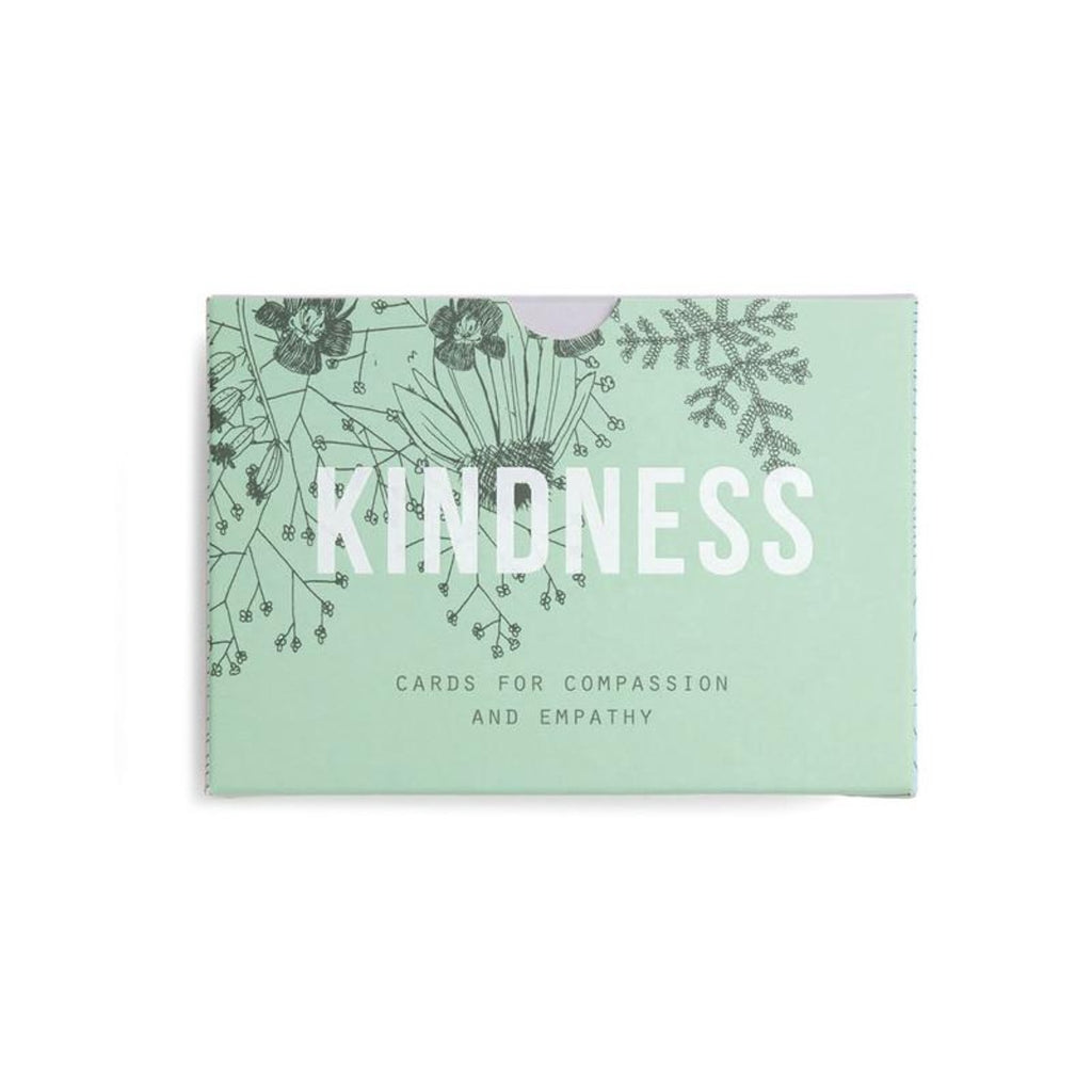 Image featuring a pastel green packaging box with a black thin illustration of flowers in the left corner, with white font in the middle reading the word - Kindness