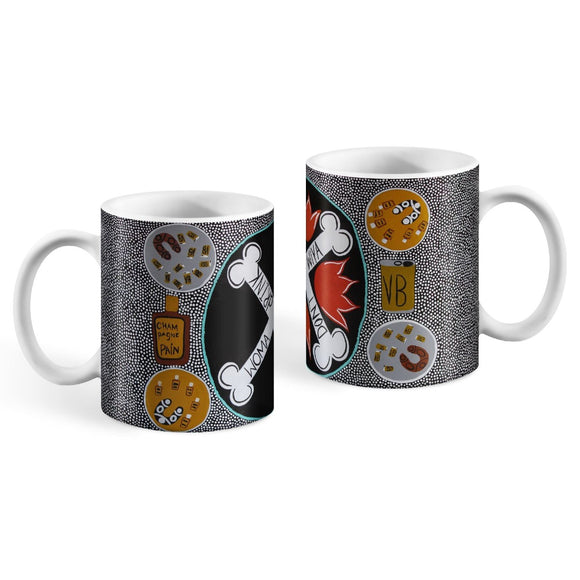 The handles of two white ceramic mugs of the same design are facing towards the side, showcasing their opposite sides. Wrapped around the mugs is the black and white dot design of Kaylene Whiskey's painting depicting two small circles near the handle on each side with a russet boomerang and glasses of VB in one circle and a black boomerang with bottles labelled 'CHAMpagne PAIN' on the other. In the centre of the design, opposite the handle, is a large black circle with two bones making an 'X' formation. 