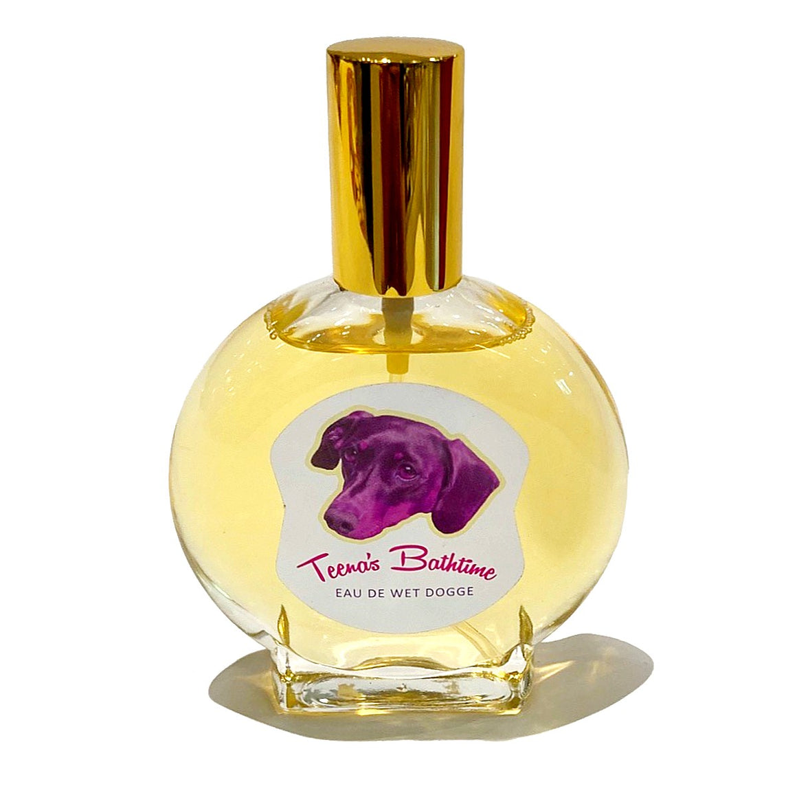 A Round perfume bottle with a gold lid. A label on the perfume bottle shows a photo of a black and tan dachshund rendered in pink and text states "Teena's Bathtime Eau De Wet Dogge"