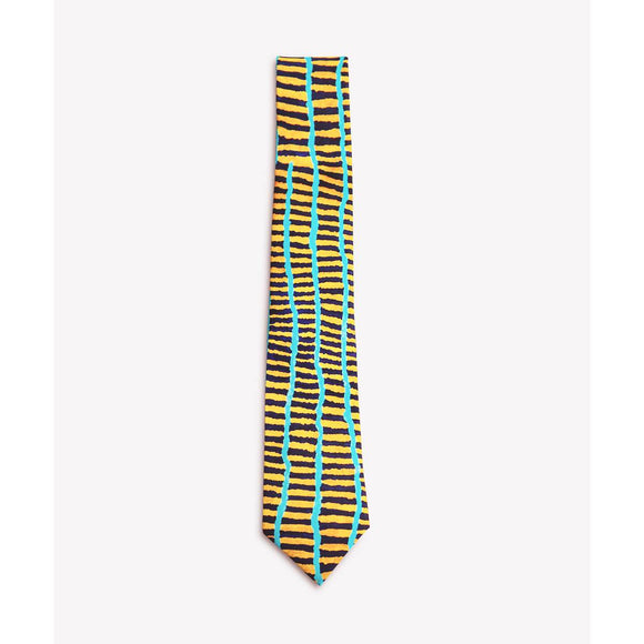 A silk tie printed with an abstract Aboriginal artwork that resmbles a grid of intersecting yellow and turquoise lines on a black background. Tie shown rolled up.