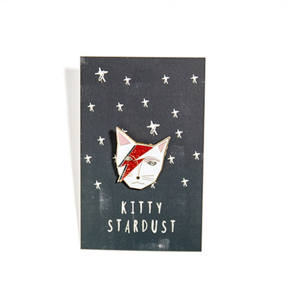 Image featuring an enamel pin in the center that has been inspired by David Bowie's song Ziggy Stardust