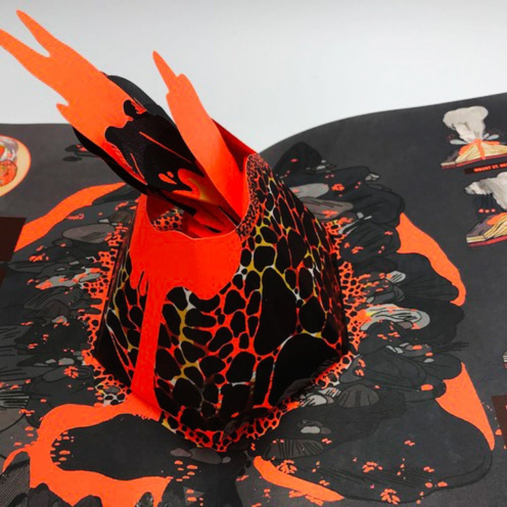 Image featuring an open page of the book, Pop-up volcano which in the centre has a pop up of a volcano eruption 