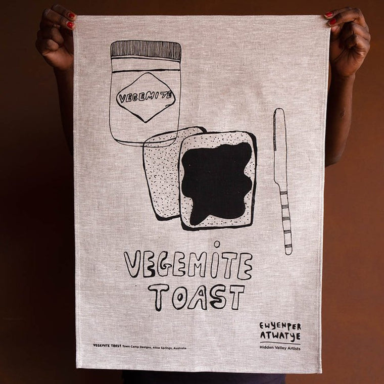 A Natural Linen Tea Towel with a black screenprinted work depicting Vegemite on toast, a Vegemite jar and a knife.. The word 'VEGEMITE TOAST' appears in bold.