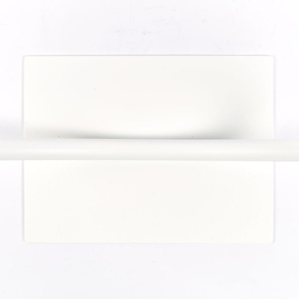 The thin white pipe creates a thin line over the flat rectangular base from the top view. 