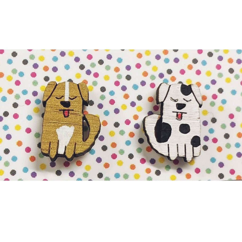 A pair of intricately hand coloured studs depicting dogs with their tongues out as if panting. The colours of the dogs vary, this pair are brown and white, and white and black